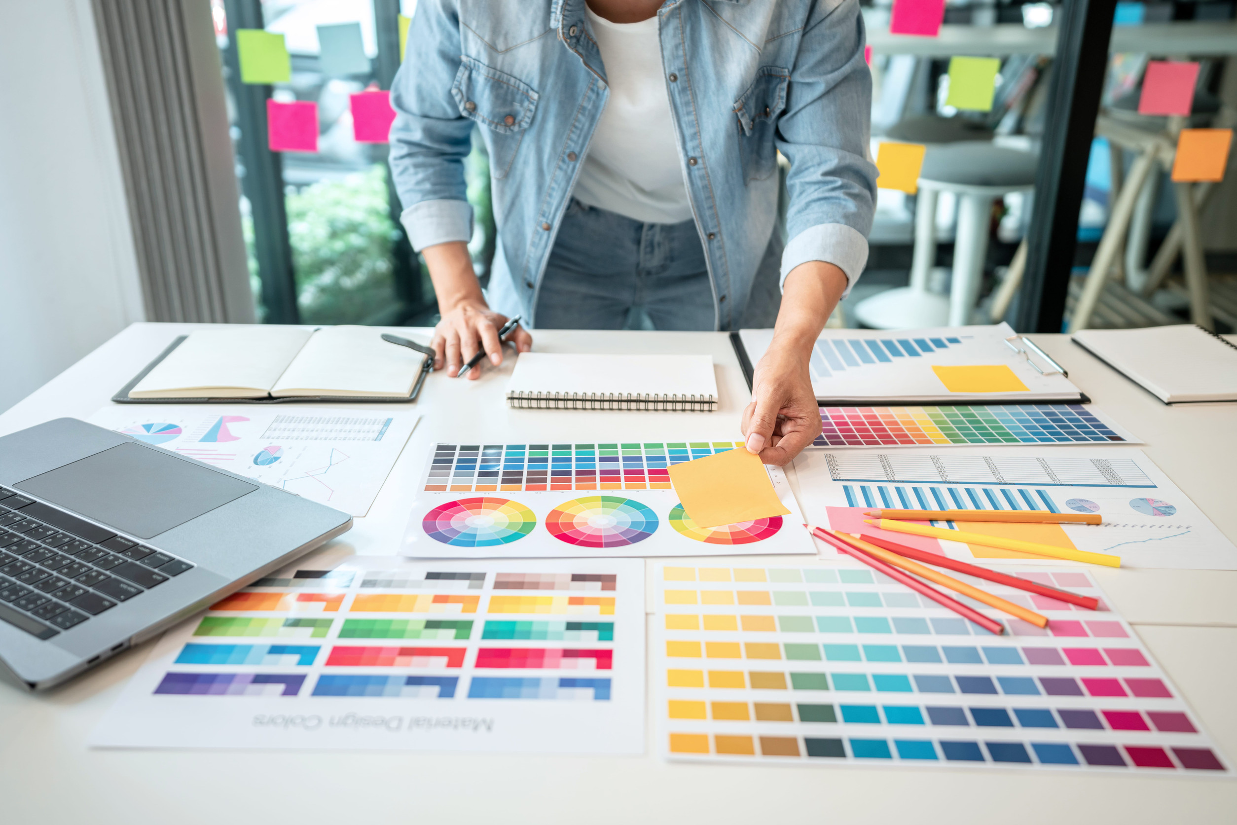 Business owner reviewing brand style guide and logo design options with a marketing team